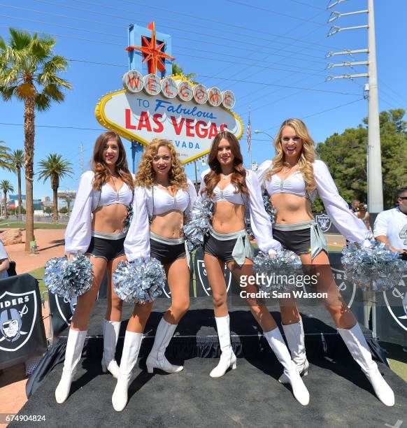 Members of the Oakland Raiderettes cheer team pose for a photo during the team's 2017 NFL Draft event at the Welcome to Fabulous Las Vegas sign on...