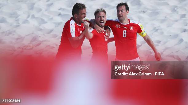 Noel Ott of Switzerland celebrates a goal with team mates Dejan Stankovic and Mo Jaeggy during the FIFA Beach Soccer World Cup Bahamas 2017 group A...
