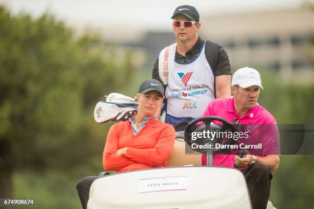 Suzann Pettersen of Norway receives a ride back to drop her ball inthe fairway at the fifteenth hole after her third shot found a water hazard during...