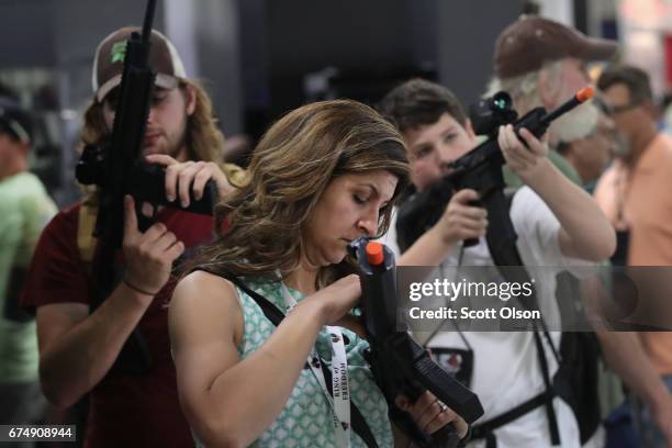 National Rifle Association members look over optics in the SIG Sauer display at the 146th NRA Annual Meetings & Exhibits on April 29, 2017 in...