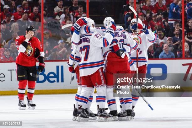 Ryan McDonagh and Mika Zibanejad of the New York Rangers celebrates a second period goal by Brady Skjei as Zack Smith of the Ottawa Senators reacts...