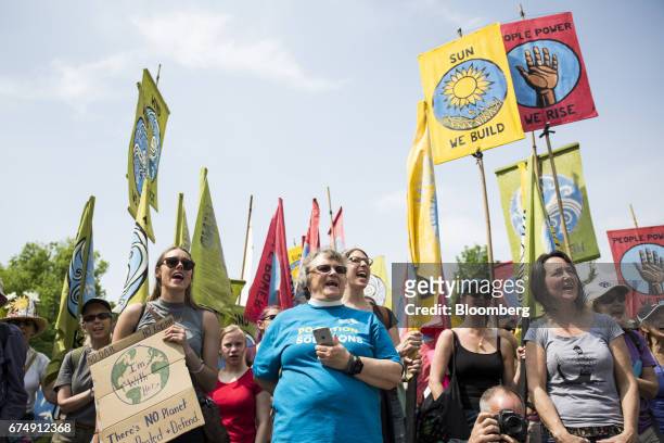 Demonstrators hold signs and chant before the start of the People's Climate Movement March in Washington, D.C., U.S., on Saturday, April 29, 2017....