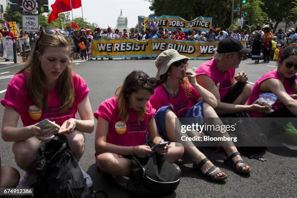 Event marshals sit on Pennsylvania Avenue as demonstrators gather before the start of the People's Climate Movement March in Washington, D.C., U.S.,...