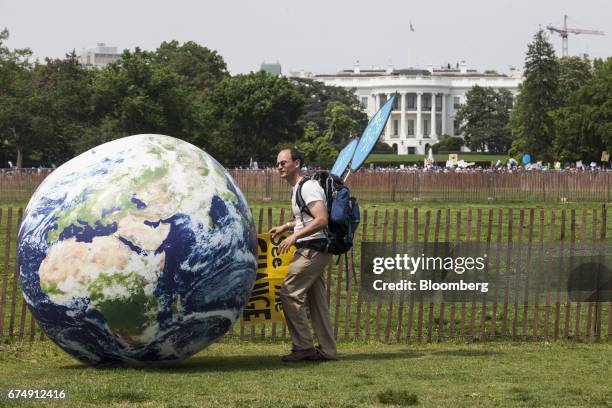 Demonstrator rolls a large globe outside of the White House during the People's Climate Movement March in Washington, D.C., U.S., on Saturday, April...