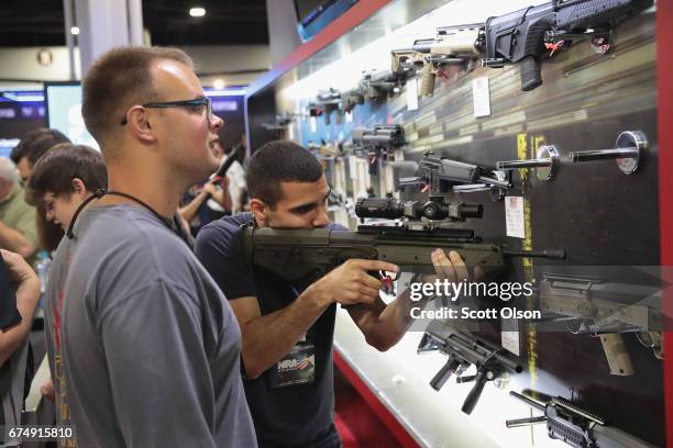 National Rifle Association members visit exhibitor booths at the 146th NRA Annual Meetings & Exhibits on April 29, 2017 in Atlanta, Georgia. With...