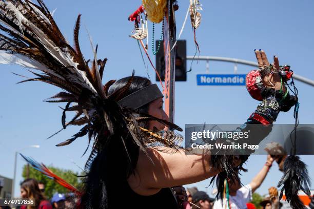 Native Americans perform a tribal ceremony before a peace rally at the intersection of Florence and Normandie, on the 25th anniversary of the LA...