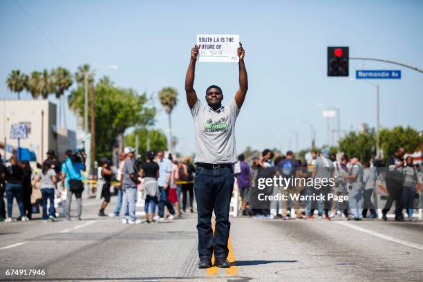 Peace rally participant, Dennis Ojogho , stands for a portrait at the intersection of Florence and Normandie, on the 25th anniversary of the LA...