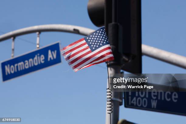 Small American flag flies on the back of a lowrider at the intersection of Florence and Normandie, on the 25th anniversary of the LA riots, on April...