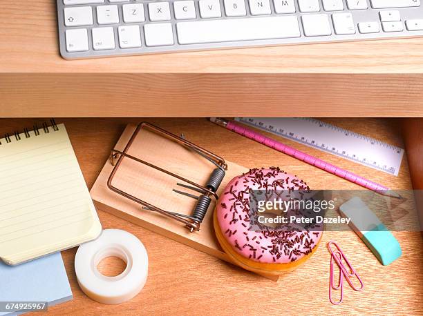 obesity issues doughnut hidden in desk drawer - ruler desk stock pictures, royalty-free photos & images