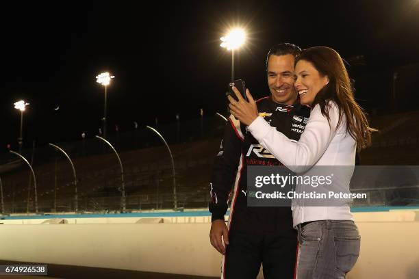 Helio Castroneves of Brazil, driver of the Team Penske Chevrolet stands on the grid with girlfriend Adriana Henao after qualifying for the Desert...