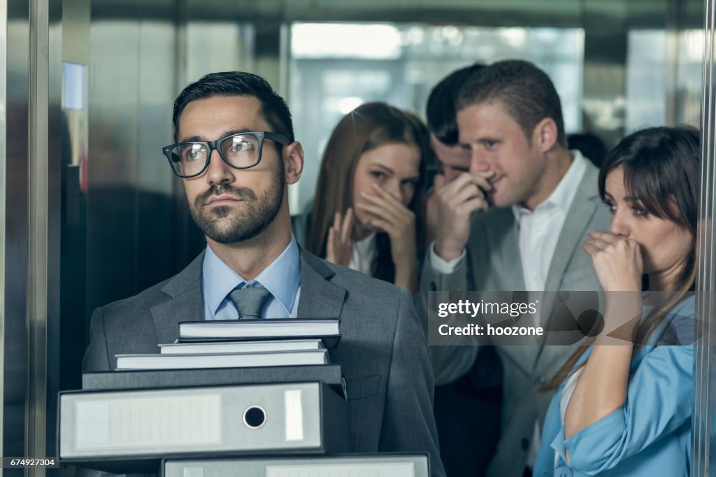 Smelly businessman affecting his coworkers in an elevator