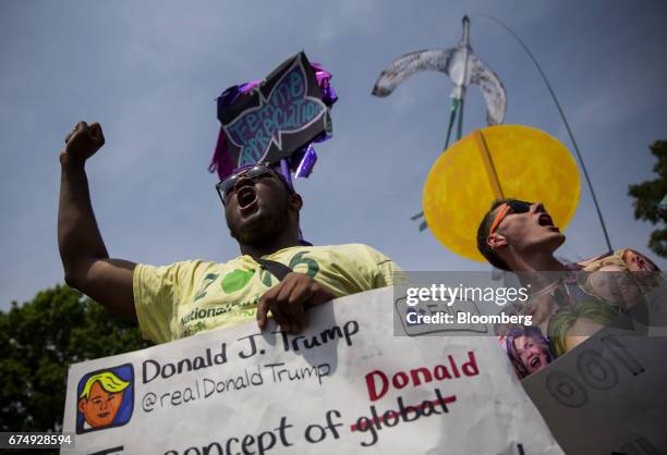 Demonstrators holds signs and chant during the People's Climate Movement March in Washington, D.C., U.S., on Saturday, April 29, 2017. Coinciding...