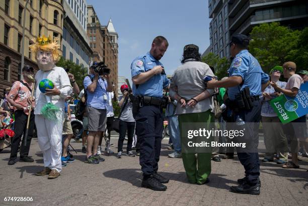 Metropolitan police officers arrest a counter protester during the People's Climate Movement March in Washington, D.C., U.S., on Saturday, April 29,...