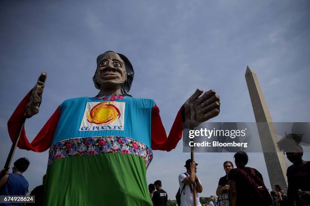 Demonstrators hold a large puppet near the Washington Monument during the People's Climate Movement March in Washington, D.C., U.S., on Saturday,...