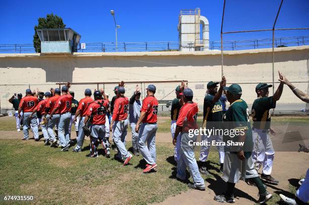 The San Quentin Athletics high-five players from the Club Mexico team from Stockton, California, on April 29, 2017 in San Quentin, California. Club...