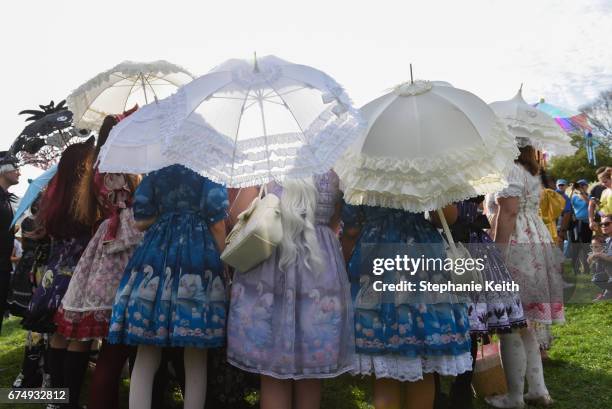 Women pose for a photo after participating in the BBG Parasol Society Fashion Show which celebrates Lolita style fashion at the Brooklyn Botanic...