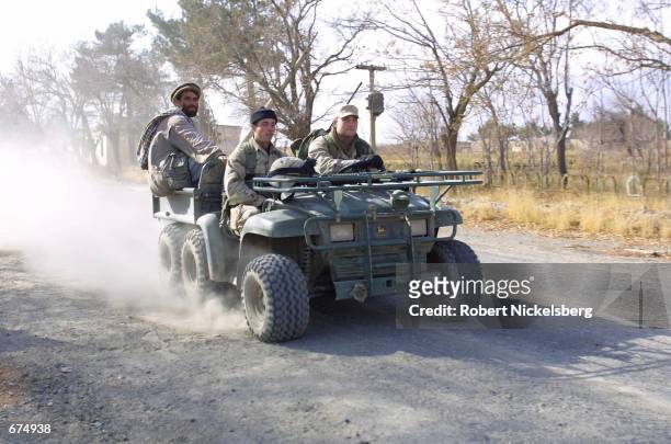 Army soldiers patrol a road in an ATV December 2, 2001 near the Bagram Air Base near Kabul, Afghanistan. While the base is under the control of...