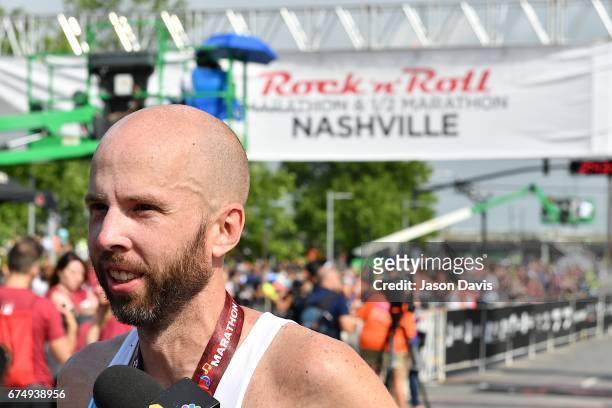 Competitor Scott Wietecha celebrates after finishing the St. Jude Rock 'n' Roll Nashville Marathon on April 29, 2017 in Nashville, Tennessee.