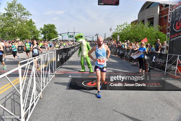 Competitor Scott Wietecha crosses the finish line during the St. Jude Rock 'n' Roll Nashville Marathon on April 29, 2017 in Nashville, Tennessee.