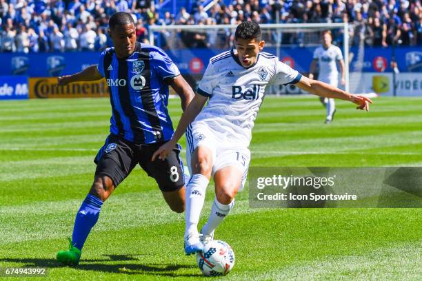 Vancouver Whitecaps midfielder Matias Laba gaining control of the ball while chased by Montreal Impact midfielder Patrice Bernier during the...