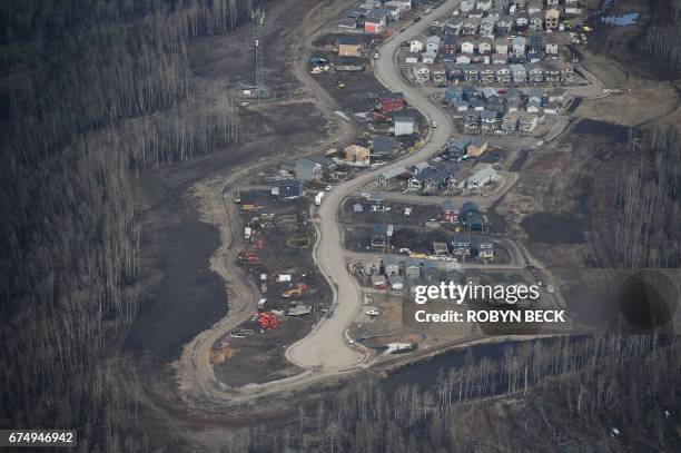 An aerial view of a residential neighborhood in Fort McMurray, Canada, where some homes have been rebuilt but many have not, one year after the Fort...