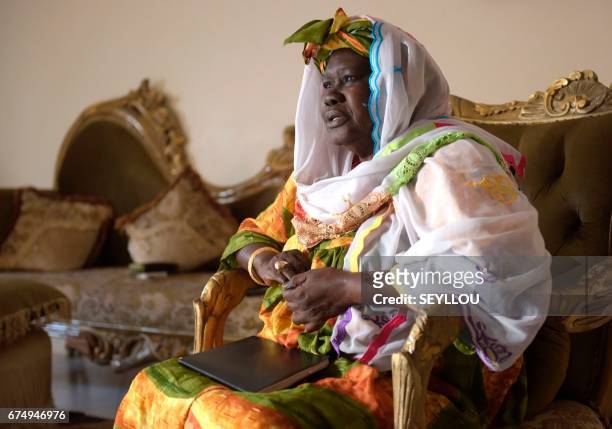 Fatou Cisse known as "Aunt Fatou", sits in her home in Grand-Mbao, on March 16 as she manages the five year long "cagnotte de la tontine" scheme...