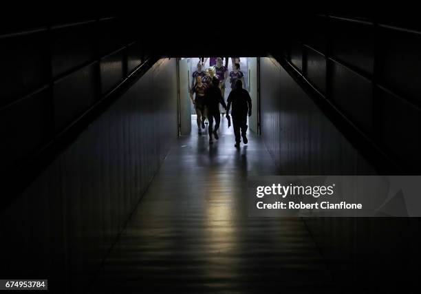 The Firebirds make their way onto the court the round 10 Super Netball match between the Magpies and the Firebirds at the Silverdome on April 30,...