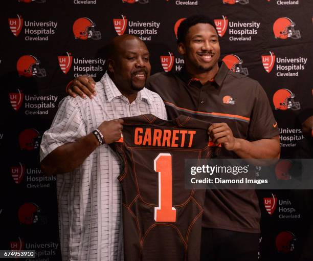 Defensive end Myles Garrett of the Cleveland Browns poses for a picture with his father, Lawrence Garrett, during a press conference after the first...