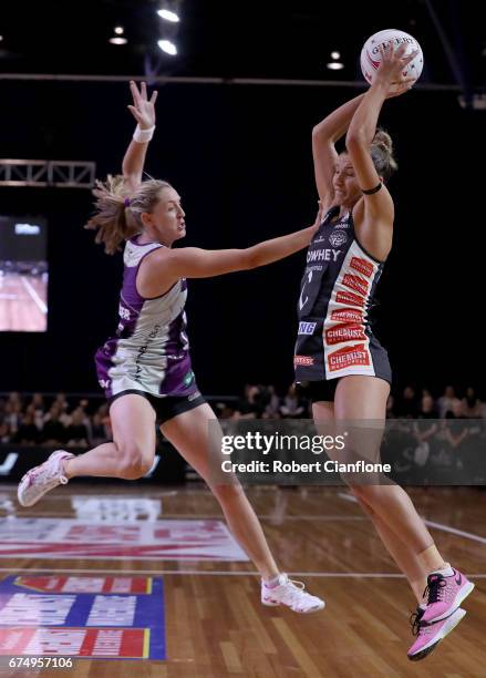 Kim Ravaillion of the Magpies is pressured by Erin Burger of the Firebirds during the round 10 Super Netball match between the Magpies and the...