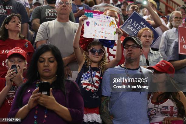 Seven-year-old Ava Nulton of Mountain Top, Pennsylvania, holds up a sign as she attends a "Make America Great Again Rally" with her parents Adam...