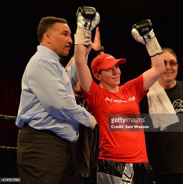 Referee Tony Weeks holds up Layla McCarter's arm after she won her welterweight fight against Szilvia Szabados at Sam's Town Hotel & Gambling Hall on...