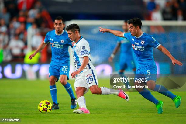 Rafael Baca and Francisco Silva of Cruz Azul fight for the ball with Victor Guzman of Pachuca during the 16th round match between Pachuca and Cruz...