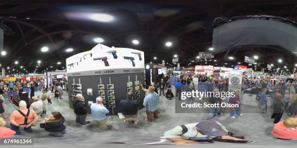 National Rifle Association members look over guns in the SIG Sauer display at the 146th NRA Annual Meetings & Exhibits on April 29, 2017 in Atlanta,...