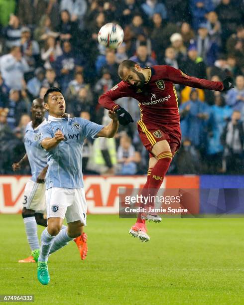 Yura Movsisyan of Real Salt Lake wins a header over Roger Espinoza of Sporting Kansas City during the game at Children's Mercy Park on April 29, 2017...