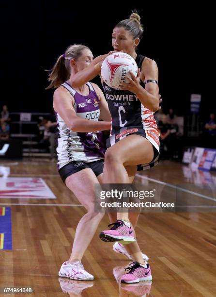 Kim Ravaillion of the Magpies is pressured by Erin Burger of the Firebirds during the round 10 Super Netball match between the Magpies and the...