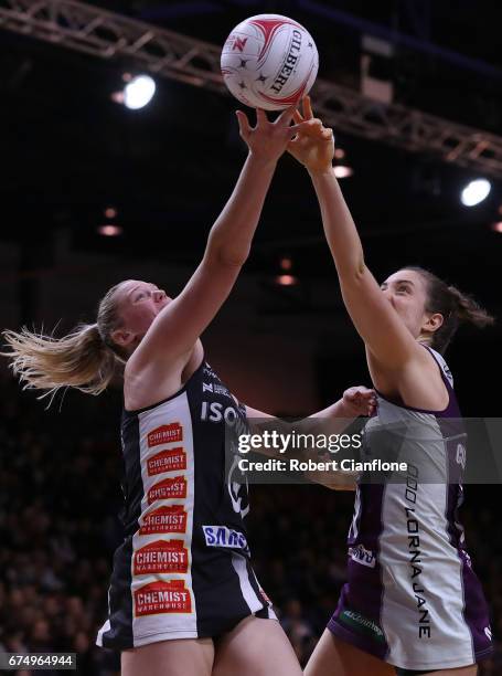 Caitlin Thwaites of the Magpies and Laura Clemesha of the Firebirds compete for the ball during the round 10 Super Netball match between the Magpies...