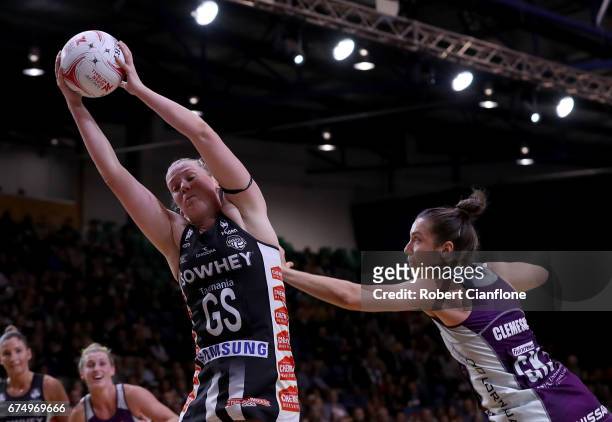 Caitlin Thwaites of the Magpies gets the ball as she is challenged by Laura Clemesha of the Firebirds during the round 10 Super Netball match between...