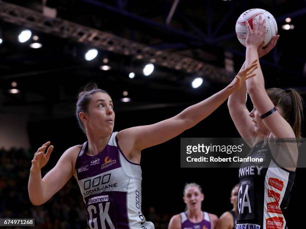 Alice Teague-Neeld of the Magpies shoots over Laura Clemesha of the Firebirds during the round 10 Super Netball match between the Magpies and the...