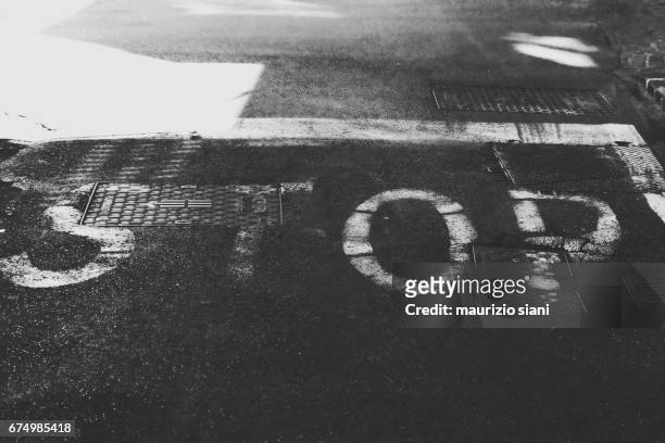 high angle view of stop sign on road - proibizione stockfoto's en -beelden