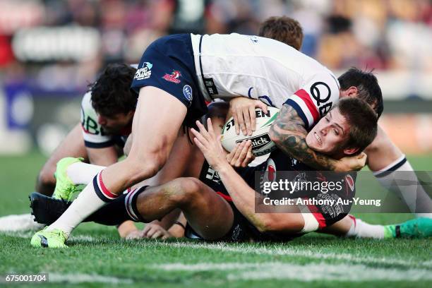 Blake Ayshford of the Warriors is tackled by Mitchell Pearce of the Roosters during the round nine NRL match between the New Zealand Warriors and the...