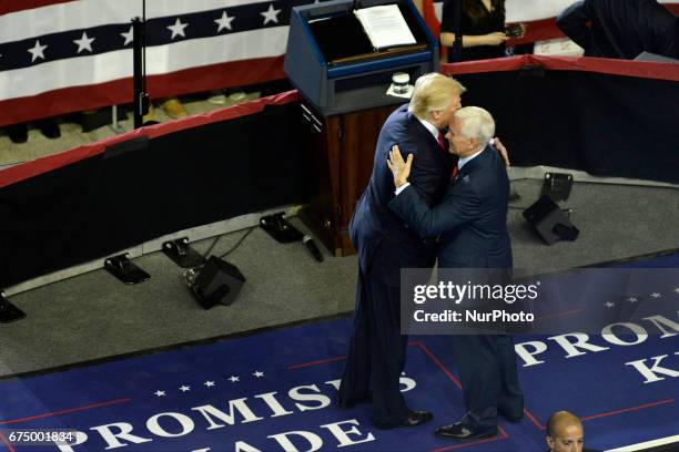 President Donald Trump is welcomed on stage by Vice-President Mike Pence at a April 29, 2017 &quot;Make America Great Again&quot; rally in...