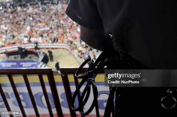 State Trooper overlooks the crowd at the April 29, 2017 campaign rally of Donald Trump, in Harrisburg, PA. The Make America Great Again event is to...