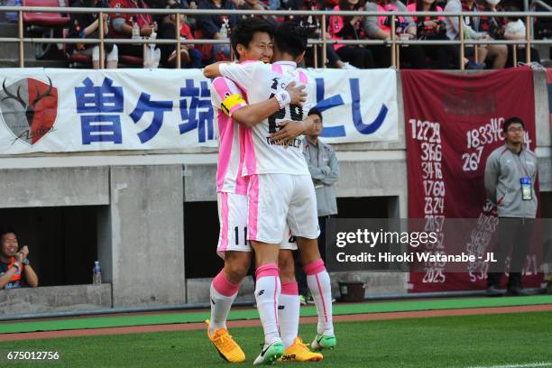 Yohei Toyoda of Sagan Tosu celebrates with his team mate Hiroyuki Taniguchi after he scores opening goal by penalty kick during the J.League J1 match...