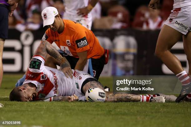 Josh Dugan of the Dragons receives attention from the trianer during the round nine NRL match between the St George Illawarra Dragons and the...