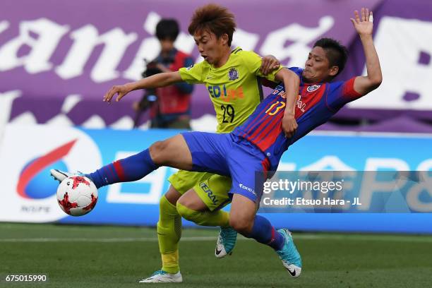 Yoshito Okubo of FC Tokyo and Tsukasa Morishima of Sanfrecce Hiroshima compete for the ball during the J.League J1 match between FC Tokyo and...