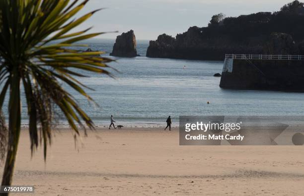 People walk on the beach St Brelade's Bay on April 13, 2017 near St Helier, Jersey. Jersey, which is not a member of the European Union, is one of...