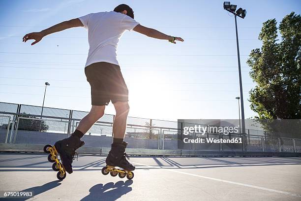 man with rollerblades during a skating session - patinaje en línea fotografías e imágenes de stock