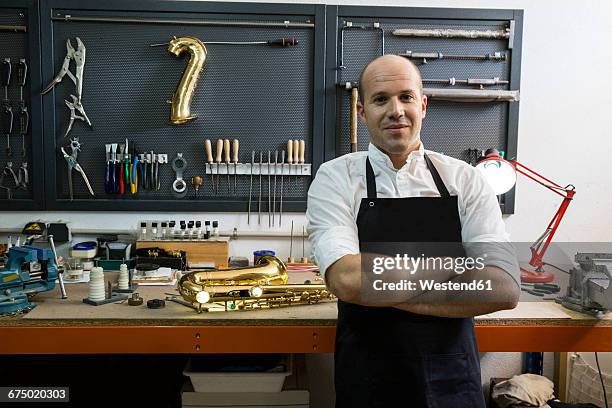 portrait of a confident instrument maker in his workshop - instrument maker fotografías e imágenes de stock