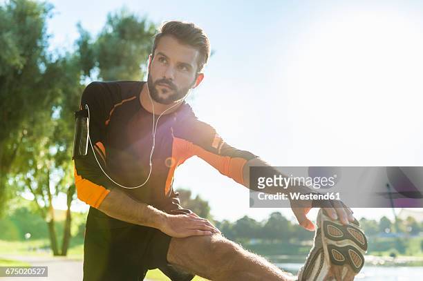 athlete stretching - sport men stock pictures, royalty-free photos & images