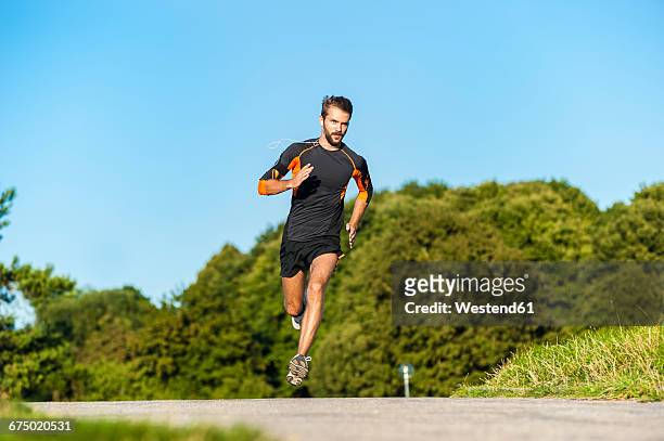 man running on rural path - jogging stock-fotos und bilder
